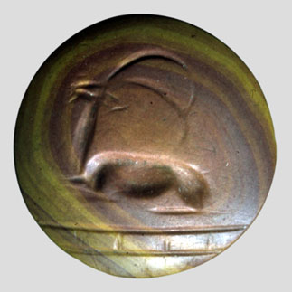 Carved stone, green and brown-swirled