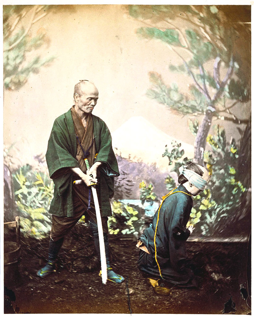 On the left, a man standing, gripping a sword with both hands; on the right, a blindfolded man kneeling with his back to the swordsman