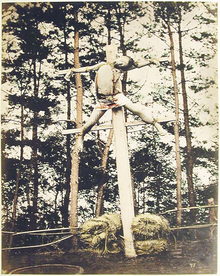 A person crucified in a forest clearing