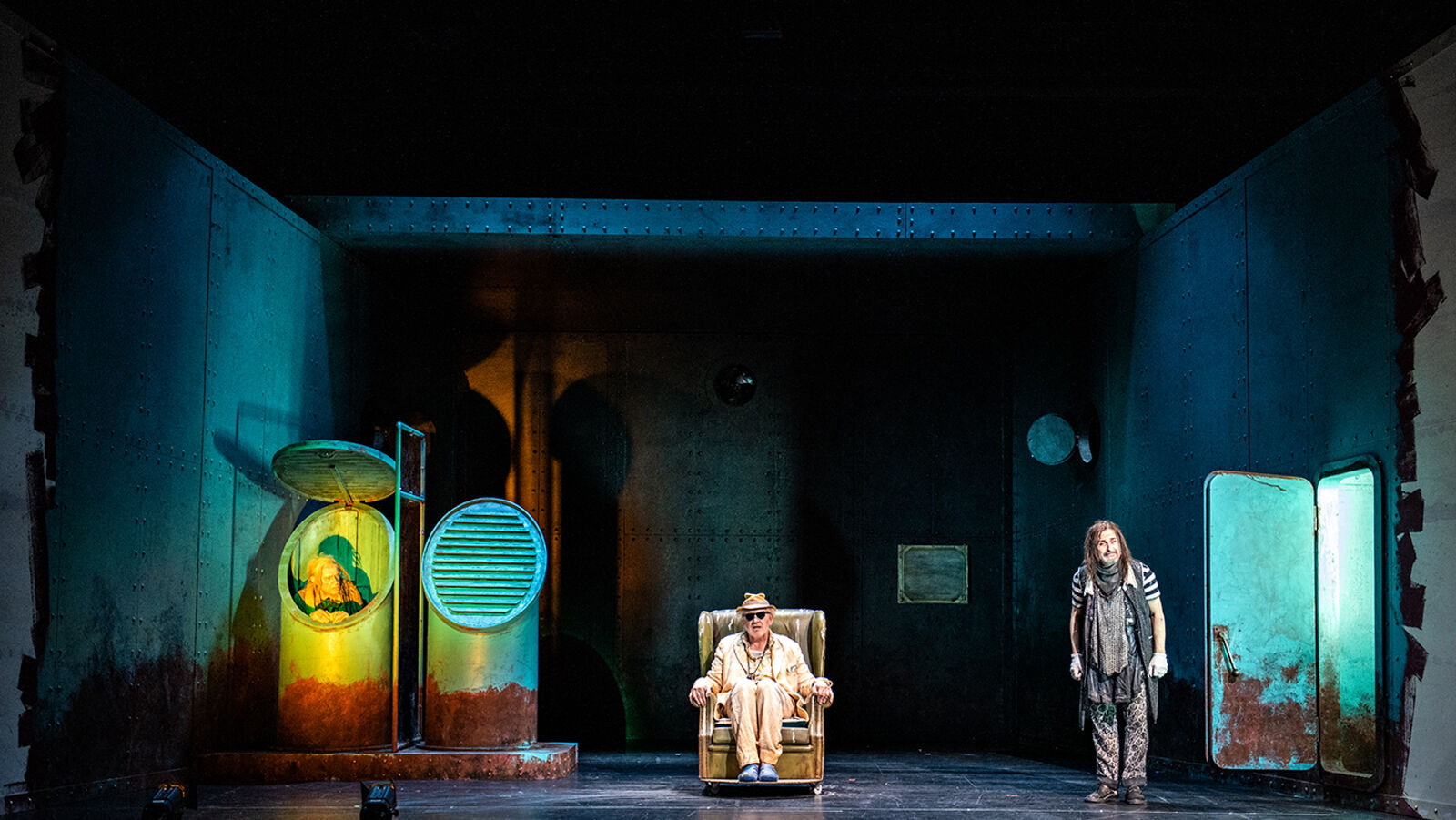 Theatre scene: three people on a rusty ship deck