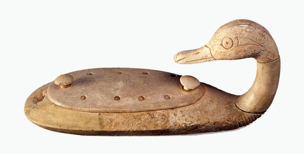 Carved duck looking at its back; looks a bit like a primitive cribbage board