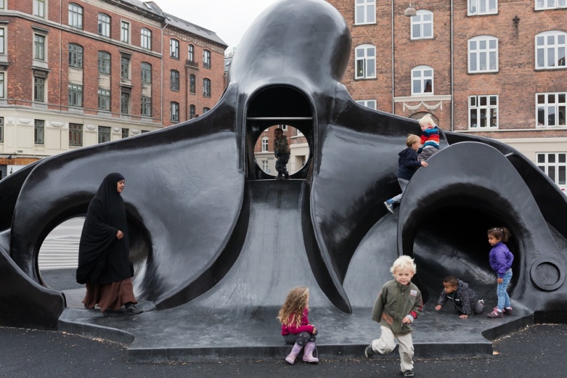 Children playing on octopus-shaped slide